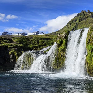 Kirkjufellsfoss Waterfall, snowy mountains, Grundarfjordur, blue sky, good Summer weather