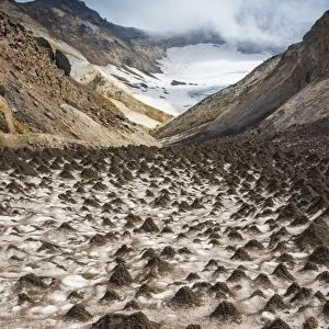 Little sand mounds on a glacier field on Mutnovsky volcano, Kamchatka, Russia, Eurasia