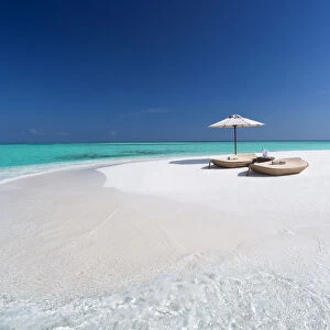 Two lounge chairs with sun umbrella on a tropical beach, The Maldives, Indian Ocean, Asia
