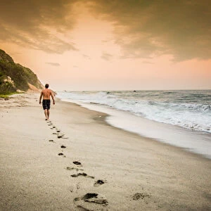 Man walking on the beach in Tayrona National Park, Colombia, South America