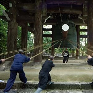 Monks pulling ropes of big bell