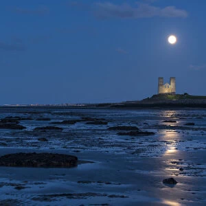Full moon rising over Reculver Towers, beach at low tide, Reculver, Herne Bay, Kent