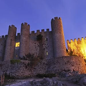 Obidos castle, today used as a luxury Pousada hotel, partially illuminated at night, Obidos, Estremadura, Portugal, Europe