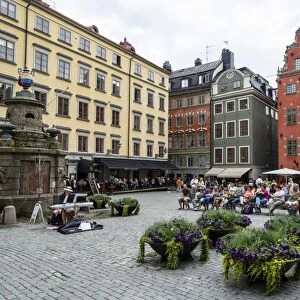 People sitting at Stortorget Square in Gamla Stan, Stockholm, Sweden, Scandinavia, Europe