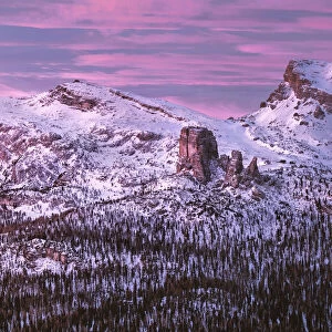 Pink sunrise on Five Towers (Cinque Torri) mountains in winter with snow, Dolomites