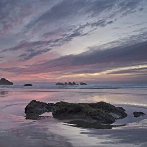 Red clouds, sea stacks, and rocks at sunset, Bandon Beach, Oregon, United States of America, North America