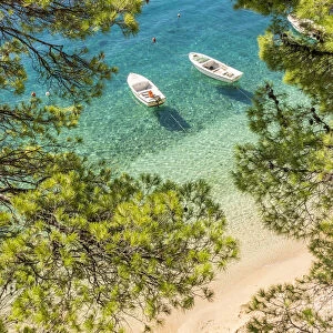 Two small boats anchored at Podrace Beach near Brela and Makarska, Croatia, Europe