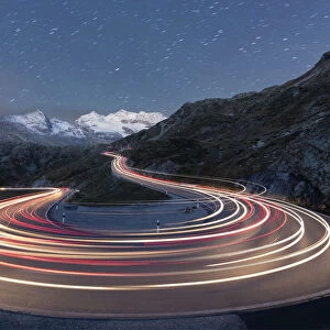 Star trail and lights of car traces, Bernina Pass, Poschiavo Valley, Engadine, Canton of Graubunden