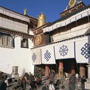 Tibetan Buddhist pilgrims prostrating in front of the Jokhang temple, Lhasa