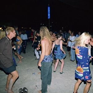 Tourists dancing at a full moon party at Haad Rin Beach