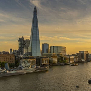 View of The Shard, HMS Belfast and River Thames from Cheval Three Quays at sunset, London