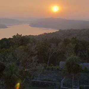 View of sunset over Lake Yaxha from Temple 216, Yaxha, Guatemala, Central America