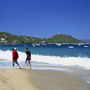 Two walkers on the beach, Campo Moro, Corsica, France, Mediterranean, Europe