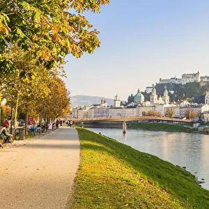 Cycle path along Salzach river with the old town in the background, Salzburg