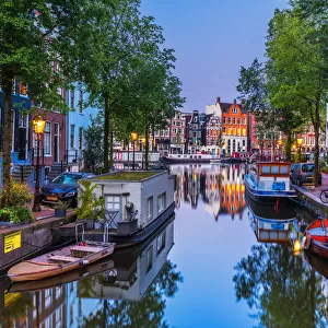 View of the Amsterdam water canal and the typical houses at dusk, Holland / Netherlands