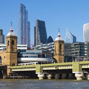 View towards skyscrapers of the City of London across Cannon Street Railway Bridge, London, England