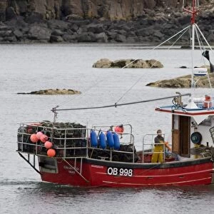 Creel boat. Eilean Ban shooting creels to catch lobster, crab etc. Hebrides, Scotland