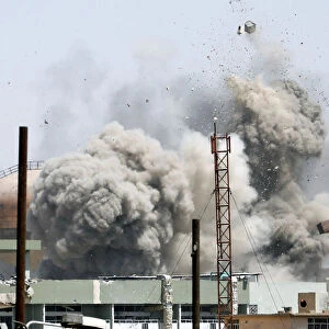 Debris fly as smoke rises after an artillery attack to the Islamic State militants