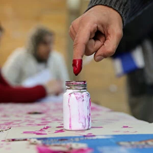 A voters finger is marked with ink at a polling station during the second day of the