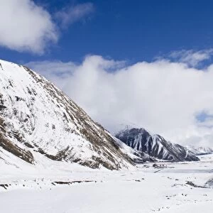 View along snow covered mountain valley, looking towards Kazbegi, Great Caucasus, Caucasus Mountains, Georgia, april
