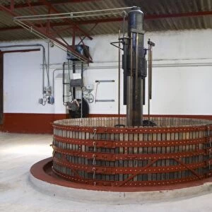 Basket wine press with the hydraulic machinery in the background, Champagne Jacquesson in Dizy