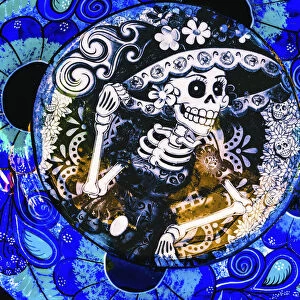 Colorful Mexican ceramic. Day of the Dead skeleton blue plate handicraft Los Cabos