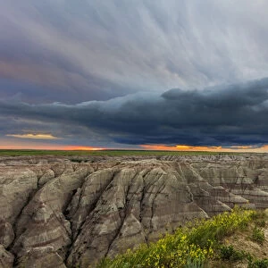 Dramatic storm cloud at sunrise in Badlands National Park, South Dakota, USA