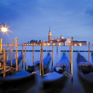 Europe, Italy, Venice. Sunset on gondolas and San Giorgio Maggiore church. Credit as