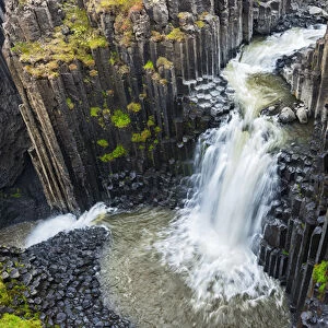 Iceland, Litlanesfoss. Waterfall and basalt columns