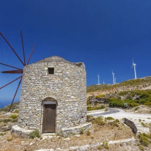 Old windmill and modern wind turbines. Naxos Island, Greece