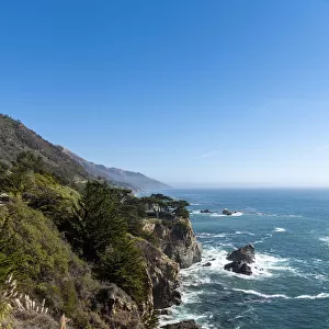 The rugged coastline of Big Sur with wisps of fog drifting into the hills