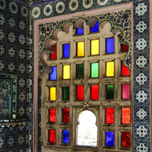 Udaipur, Rajasthan, India. Stain glass window with byzantine tile and scallop arch