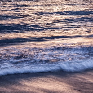 USA, California, La Jolla, Sunset color reflected in waves at Windansea Beach