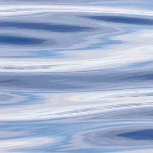 Waves reflecting sky in blue, grey and silver Atlantic ocean near the coast of southern greenland