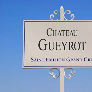 A white sign in the vineyard saying Chateau Gueyrot Saint Emilion Grand Cru Saint