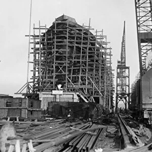 ALEXANDRIA SHIP YARDS. Construction of a large steamship enclosed in wooden scaffolding