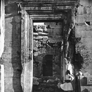 ATHENS: ACROPOLIS, 1870. A man standing near a doorway among the ruins of the Acropolis at Athens
