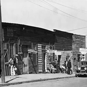 BARBERSHOPS, 1936. A row of African American barbershops in Vicksburg, Mississippi