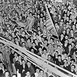 COSTA RICA, c1942. A crowd of men with the Costa Rican and American flags in Costa Rica