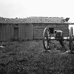 GETTYSBURG, c1919. A cannon in front of a log cabin at the Gettysburg National