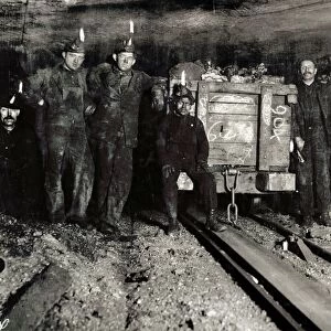 Group of coal miners resting with a load at the top of a slope in a mine shaft of the Pennsylvania Coal Company in Pittston, Pennsylvania. Photograph by Lewis Hine, 1911