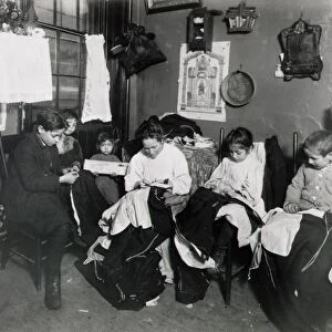 IMMIGRANTS: PIECEWORK. An Italian immigrant family doing garment piecework in their