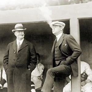 JOHNSON & RUTH, 1922. American baseball executive Ban Johnson (left) smoking cigars at a baseball game in Washington, D. C, with New York Yankees star Babe Ruth, 12 April 1922