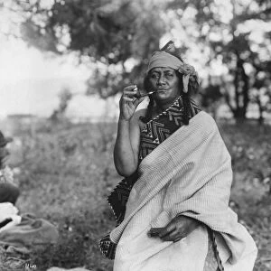MAORI WOMAN, c1910. A Maori woman smoking a pipe. Photograph, c1910
