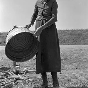 MIGRANT WOMAN, 1939. A grandmother at a migrant camp in Stanislaus County, California