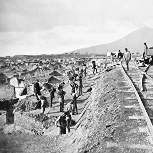 POMPEII: EXCAVATION, 1881. An excavation of Pompeii, Italy, with Mount Vesuvius in the background