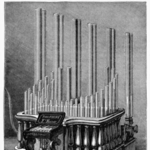 PYROPHONE, 1875. A pyrophone, or gas organ, a musical instrument in which tones are produced by flames of hydrogen burning in tubes of different sizes and legnths. Wood engraving, American, 1875