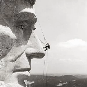SCALING MOUNT RUSHMORE. Scaling the face of President Abraham Lincoln at the Mount Rushmore National Memorial in South Dakota, 1937