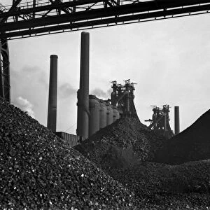 STEEL FACTORY, 1941. Piles of iron ore in front of the blast furnaces at the Carnegie-Illinois