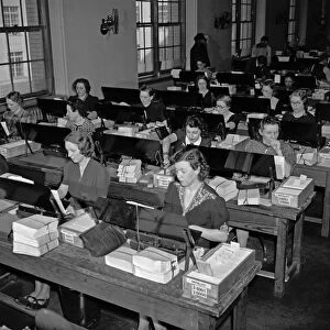 TABULATING MACHINES, c1940. Women operating tabulating machines, possibly processing